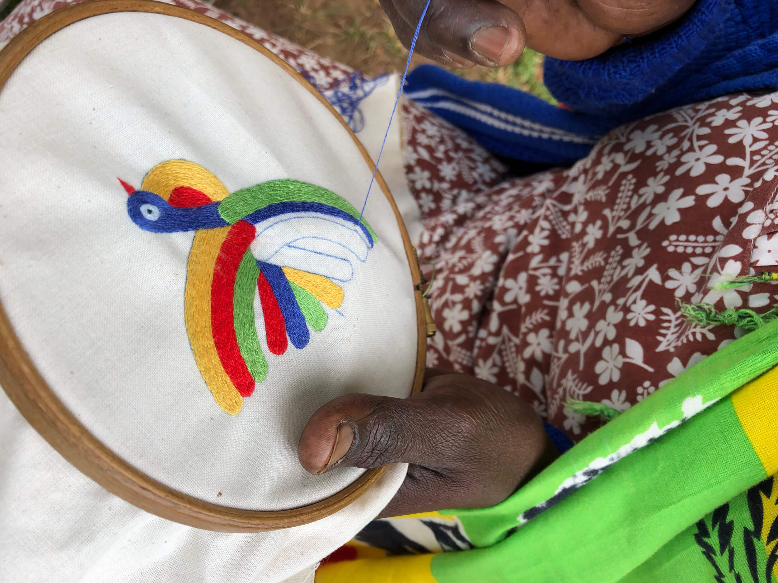 A close-up of a sample hand-embroidered gift of the Peace by Piece International logo