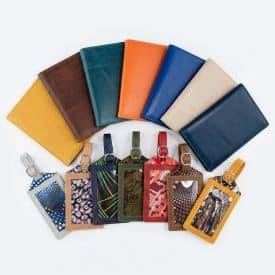 Dokmai matching passport holders and luggage tags Matching passport holders and luggage tags fanned out against a white background