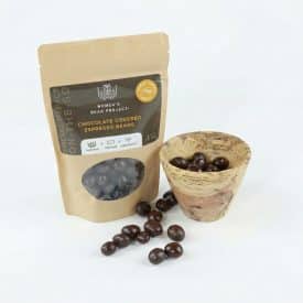 little luxuries gift set a bag of chocolate covered espresso beans and a small wooden bowl with some inside. also some chocolate covered espresso beans scattered around the two