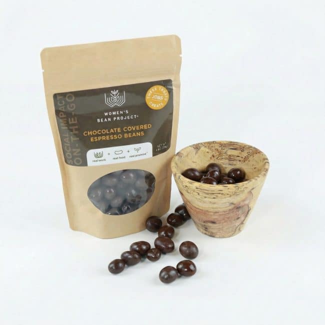 little luxuries gift set a bag of chocolate covered espresso beans and a small wooden bowl with some inside. also some chocolate covered espresso beans scattered around the two