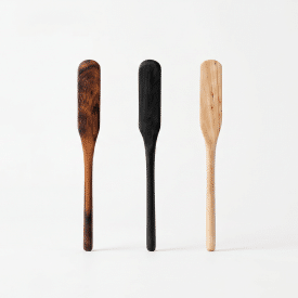Four handcrafted wooden jam spreaders in a variety of wood types stand against a white background