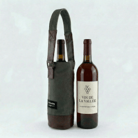 A wine bottle tote with a bottle of wine inside of it and a bottle of wine next to it