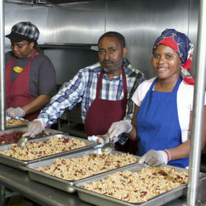 Three Beautiful Day workers craft the gourmet granola that goes into our Good Morning breakfast gift baskets.