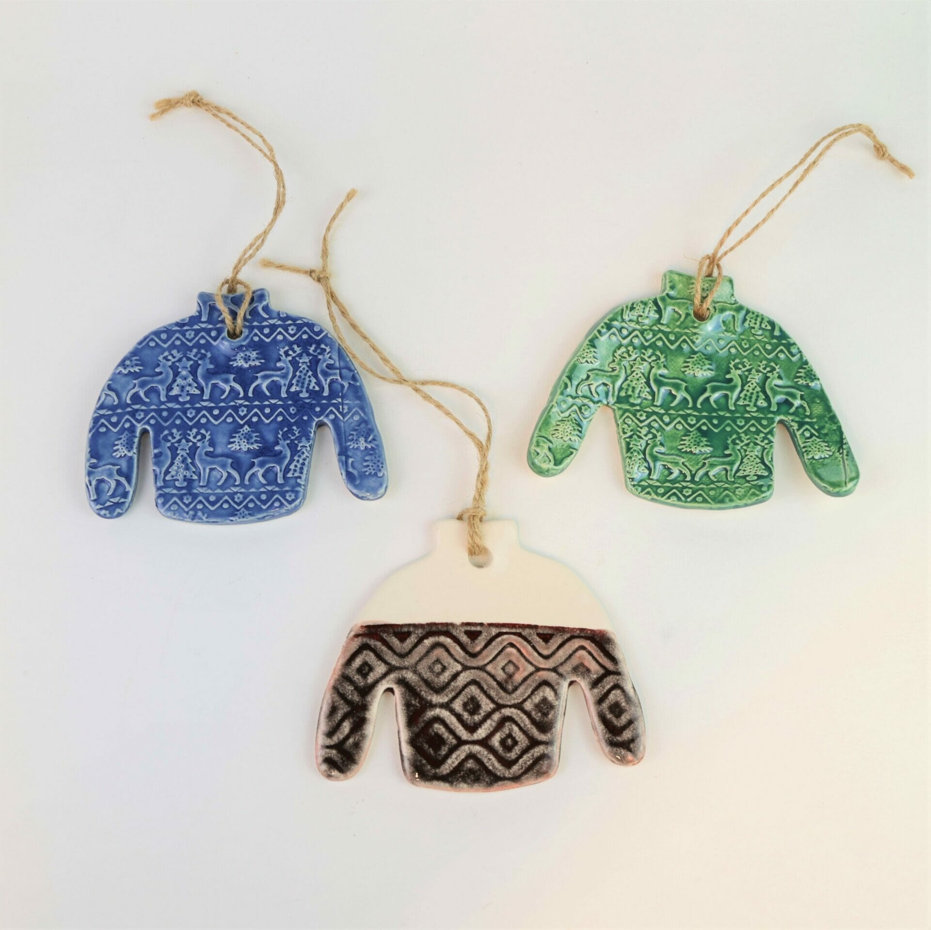 Three ugly sweater custom ornaments in various colors