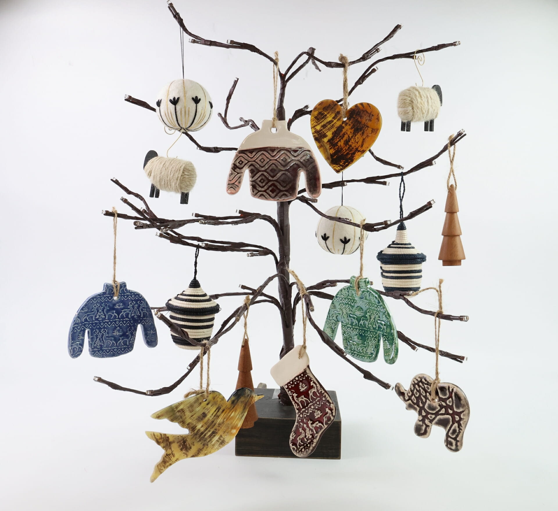 An array of custom ornaments handing on a decorative tree