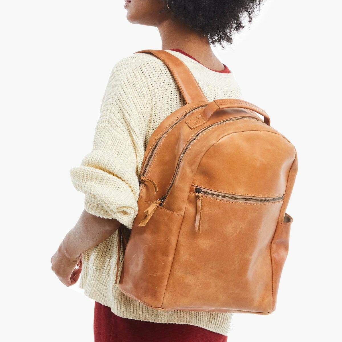 This leather backpack for travel is stylishly modeled.