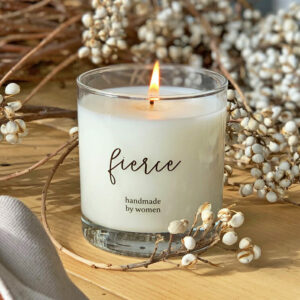 This 8-oz candle is in a glass jar with the word "fierce" and "handmade by women". It's one of our motivational candles for employees.