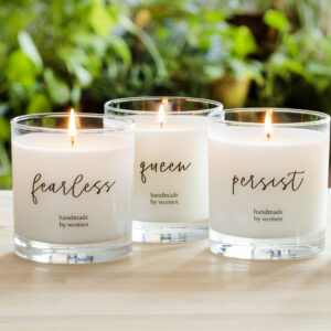 Three 8-oz candles with the words "fearless," "queen," and "persist," with "handmade by women" underneath. Choose any of our motivational candles for employees.