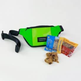 upcycled adventure An upcycled green fanny pack and granola snacks make a great gift set for company offsites
