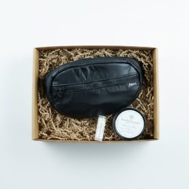 A belt bag made my women who have been rescued from sex work is paired with a lotion bar and lip moisturizer made by women survivors