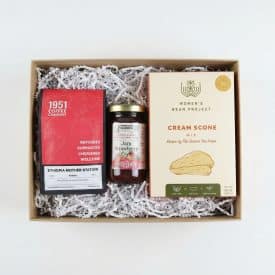 Slow Mornings Gift Box White Background An ethical gift of coffee, jam, and scones placed in a gift box with white crinkle paper.