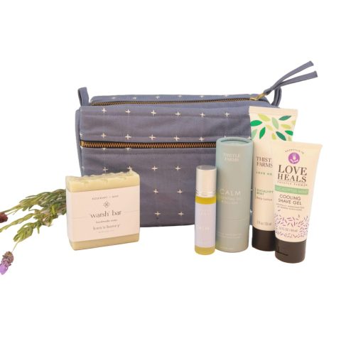 wellness gift set with a blue bag, warsh bar, essential oils, body lotion, and cooling shave gel