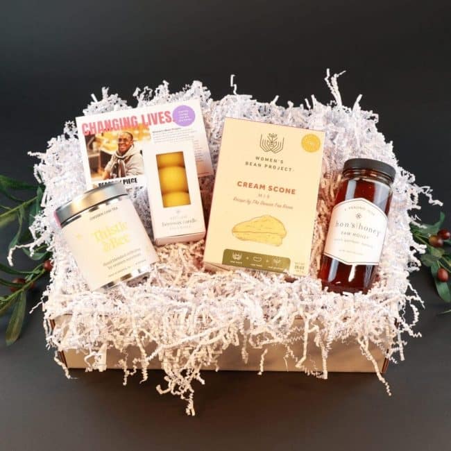 Gift set that includes tea, a candle, scone mix, and infused raw honey