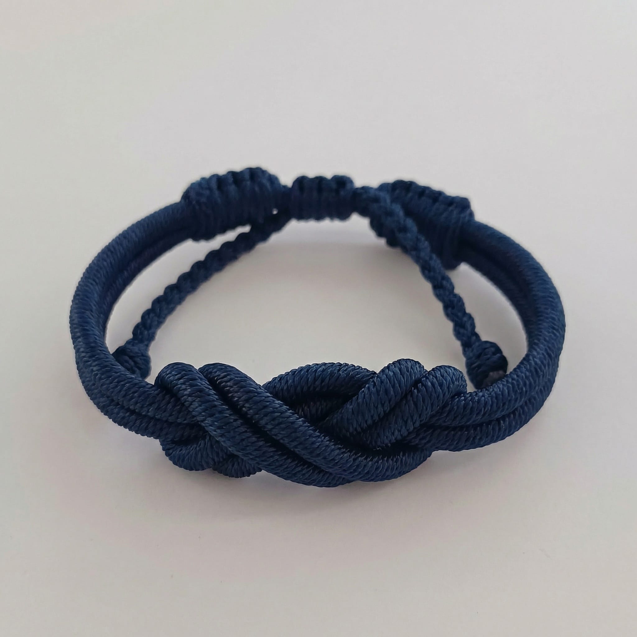 RISE Twisted Knot Bracelet in blue a handmade red bracelet with a large twisted decorative knot. A unique corporate gift idea