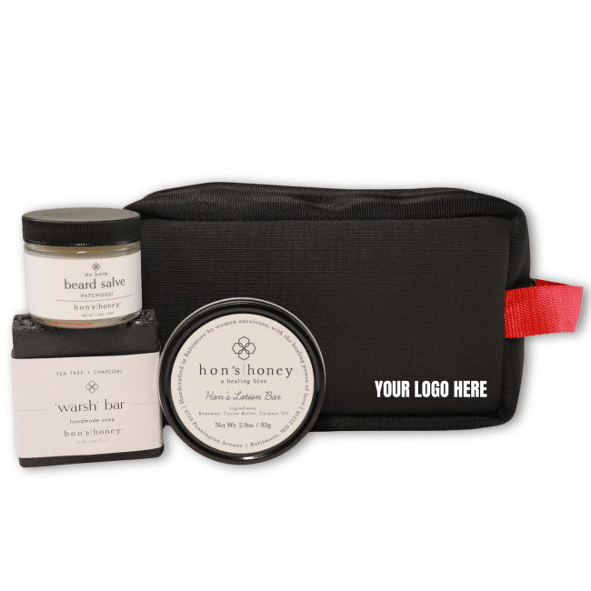 Modern Man's Wellness Kit. It contains a soap, bar lotion and beard salve in a black and red pouch. Perfect for corporate gifting