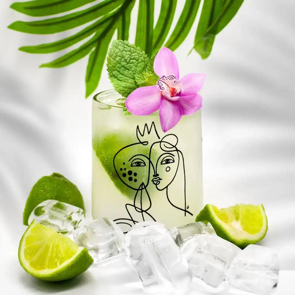 a unique international women's day gift - a glass made from upcycled bottles in Guatemala with an abstract print of a woman's face on it