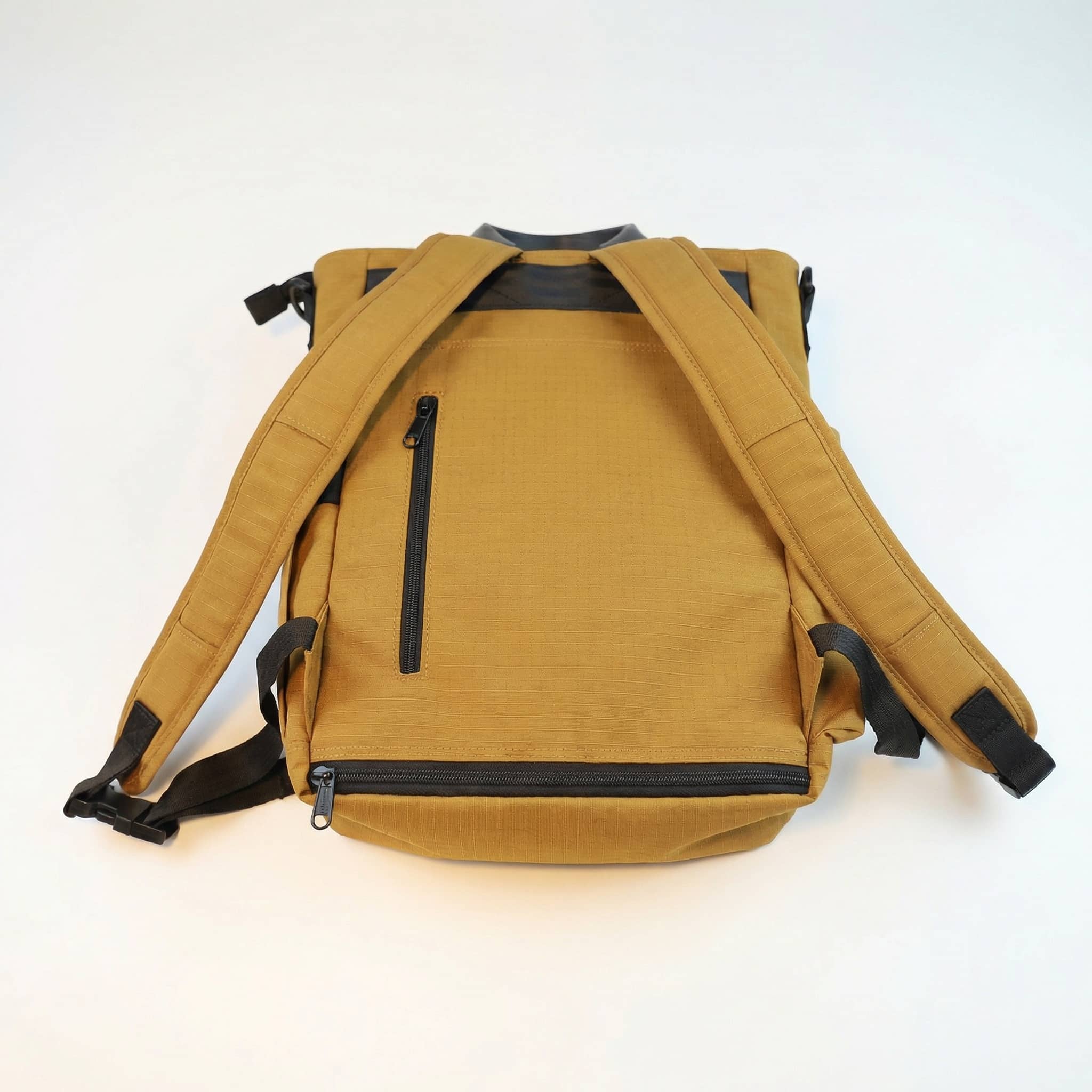 NoBoundaries Travel Edition Back View Gold a back view of a gold backpack with a "hidden" security zipper pocket and optional zippered "sleeve" for attaching it to a roller bag