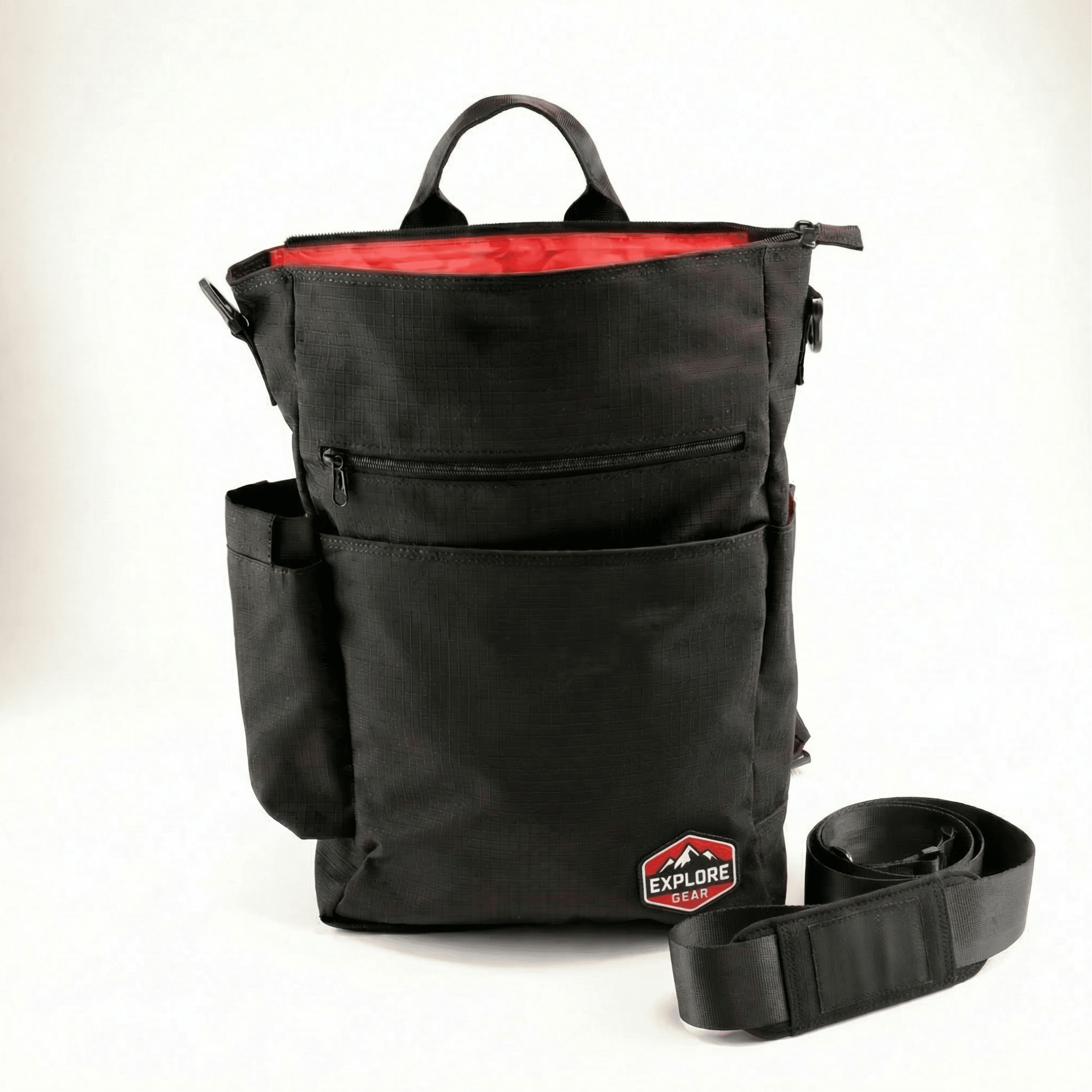 NoBoundaries TravelEdition (1) A black backpack with red details and interior. A removable strap made from upcycled seatbelts sits next to it.