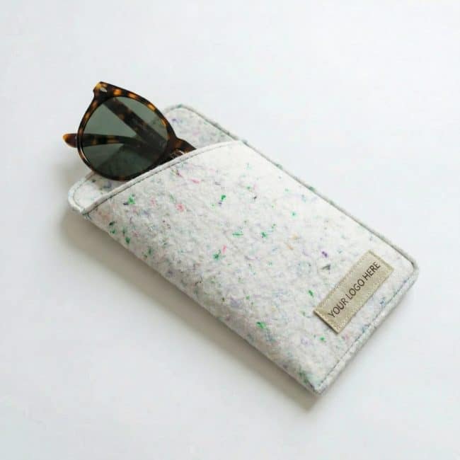a cream colored felt sunglasses case holding a pair of sunglasses