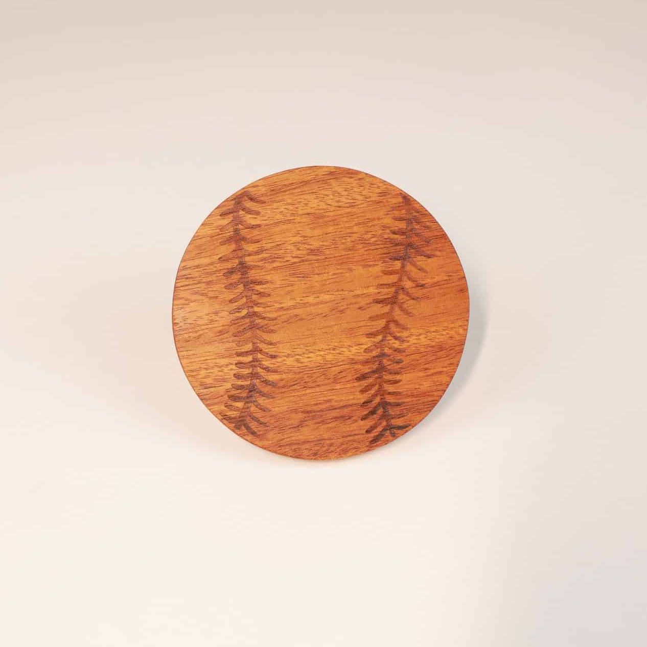 itza wood baseball coaster a single coaster engraved to look like a baseball is propped up against a white background